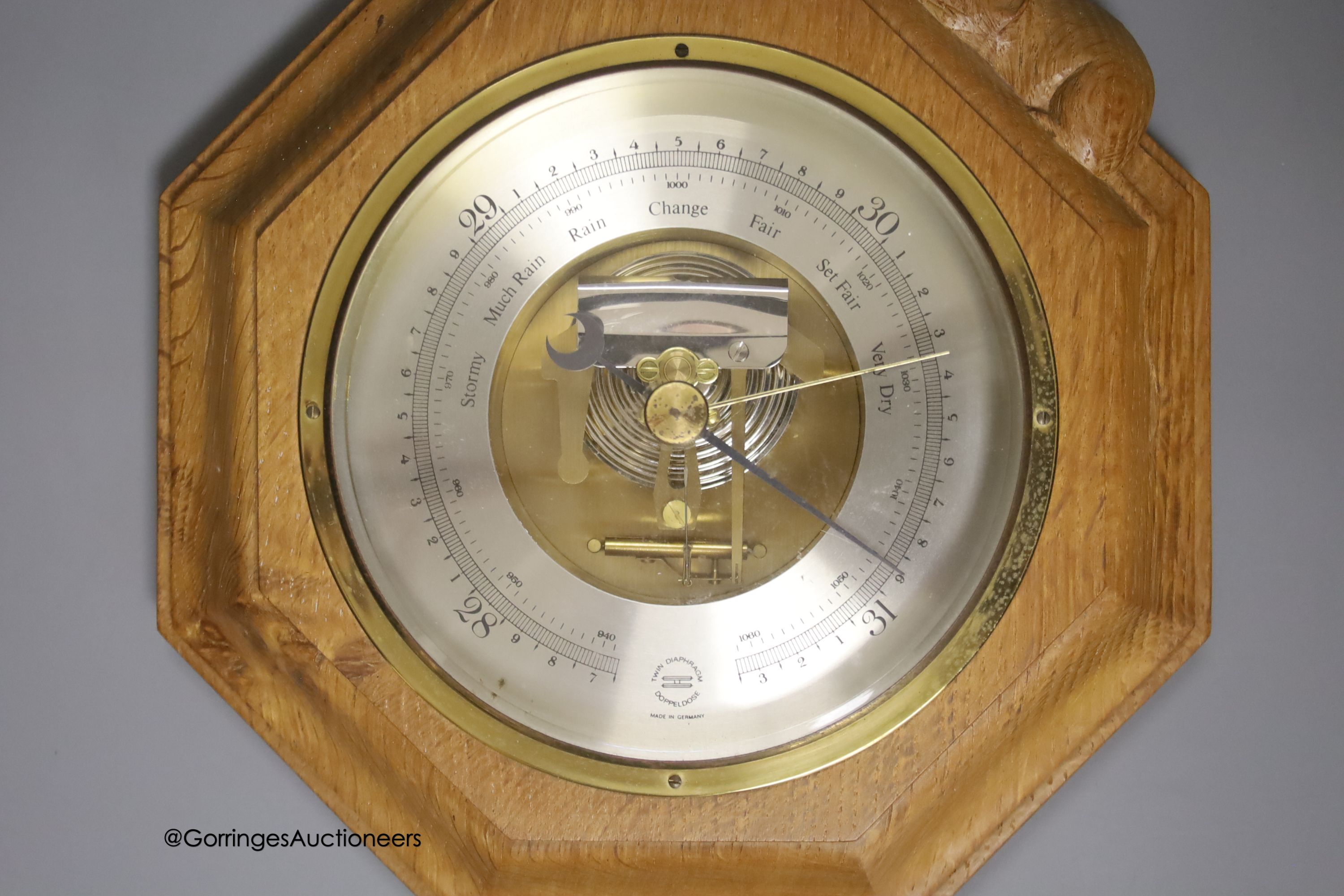A Mouseman octagonal oak aneroid barometer, 21cm